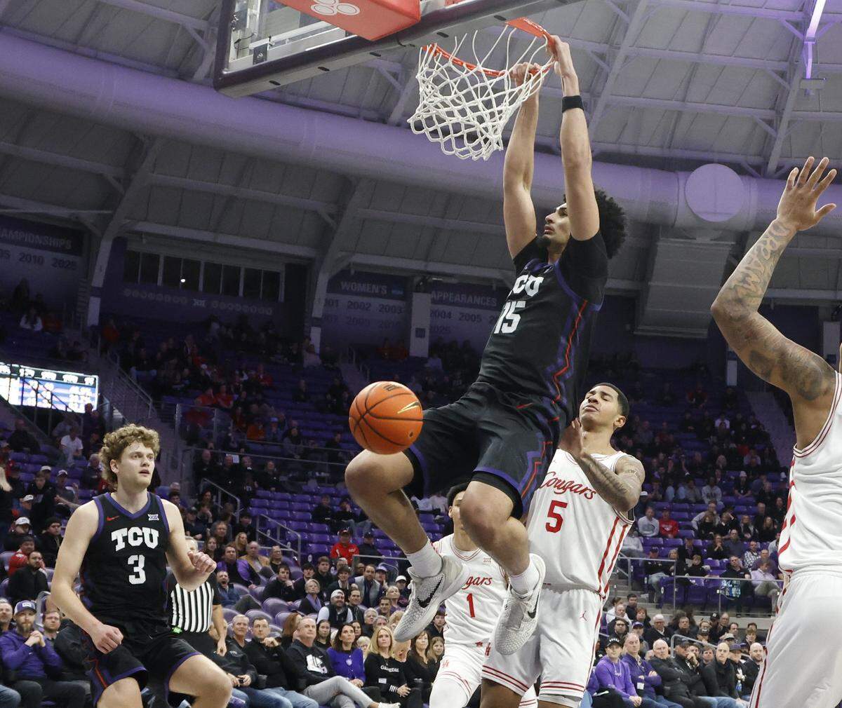 TCU forward David Punch (15) rim hangs after his bucket against Houston during the second half of a NCAA basketball game between the University of Houston and TCU at Schollmaier Arena in Fort Worth, Texas, Wednesday Jan. 26, 2026