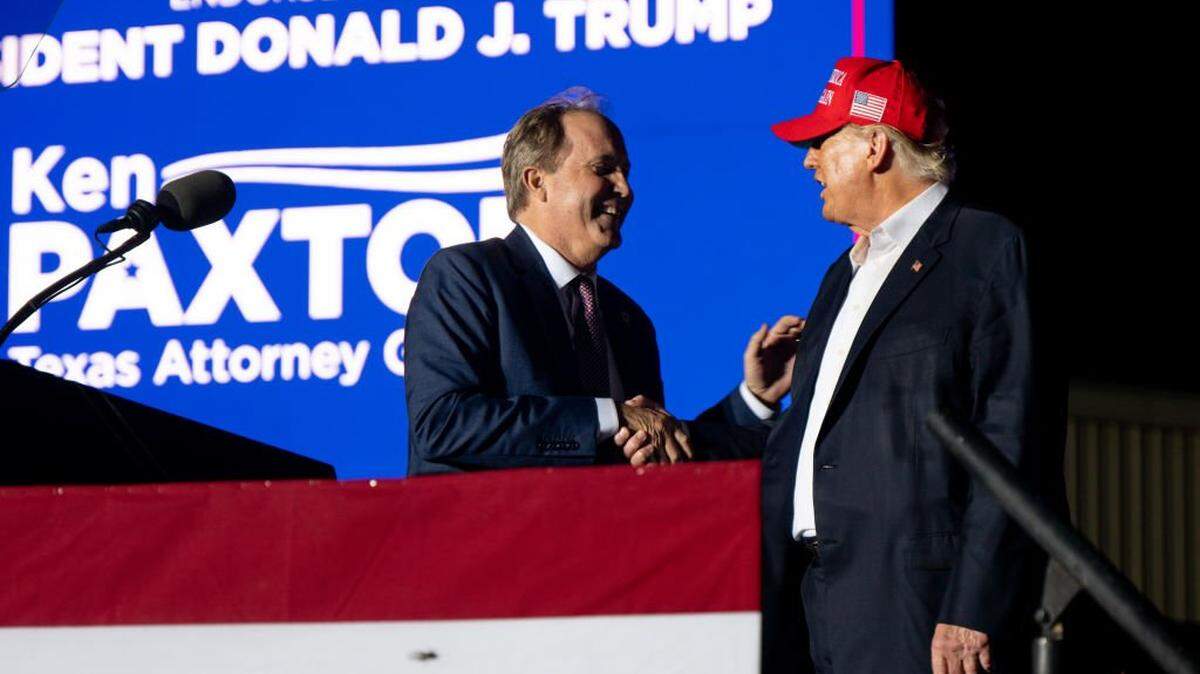 ROBSTOWN, TEXAS - OCTOBER 22: (L-R) Texas Attorney General Ken Paxton greets former U.S. President Donald Trump at the 'Save America' rally on October 22, 2022 in Robstown, Texas. The former president, alongside other Republican nominees and leaders held a rally where they energized supporters and voters ahead of the midterm election. (Photo by Brandon Bell/Getty Images)