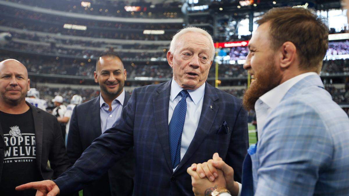 Dallas Cowboys owner Jerry Jones, second from right, and UFC fighter Conor McGregor, right, are seen on the sidelines before an NFL football game against the Jacksonville Jaguars on Sunday. The UFC has never held a fight at AT&T Stadium and McGregor is the one name big enough to consider the Octagon will come to Arlington.