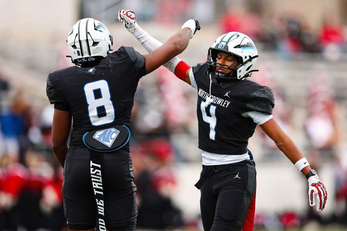 North Crowley defensive back Jerry Outhouse (4) celebrates after making a stop with teammate DeMorey Beasley in a Class 6A Division I regional playoff against Coppell on Saturday, Nov. 29, 2025, at Midlothian ISD Stadium in Midlothian.