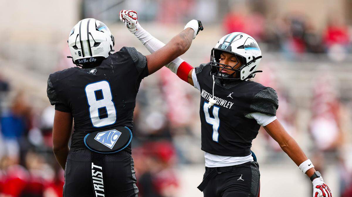 North Crowley defensive back Jerry Outhouse (4) celebrates with DeMorey Beasley after making a stop in a Class 6A Division I regional playoff against Coppell on Nov. 29 at Midlothian ISD Stadium.