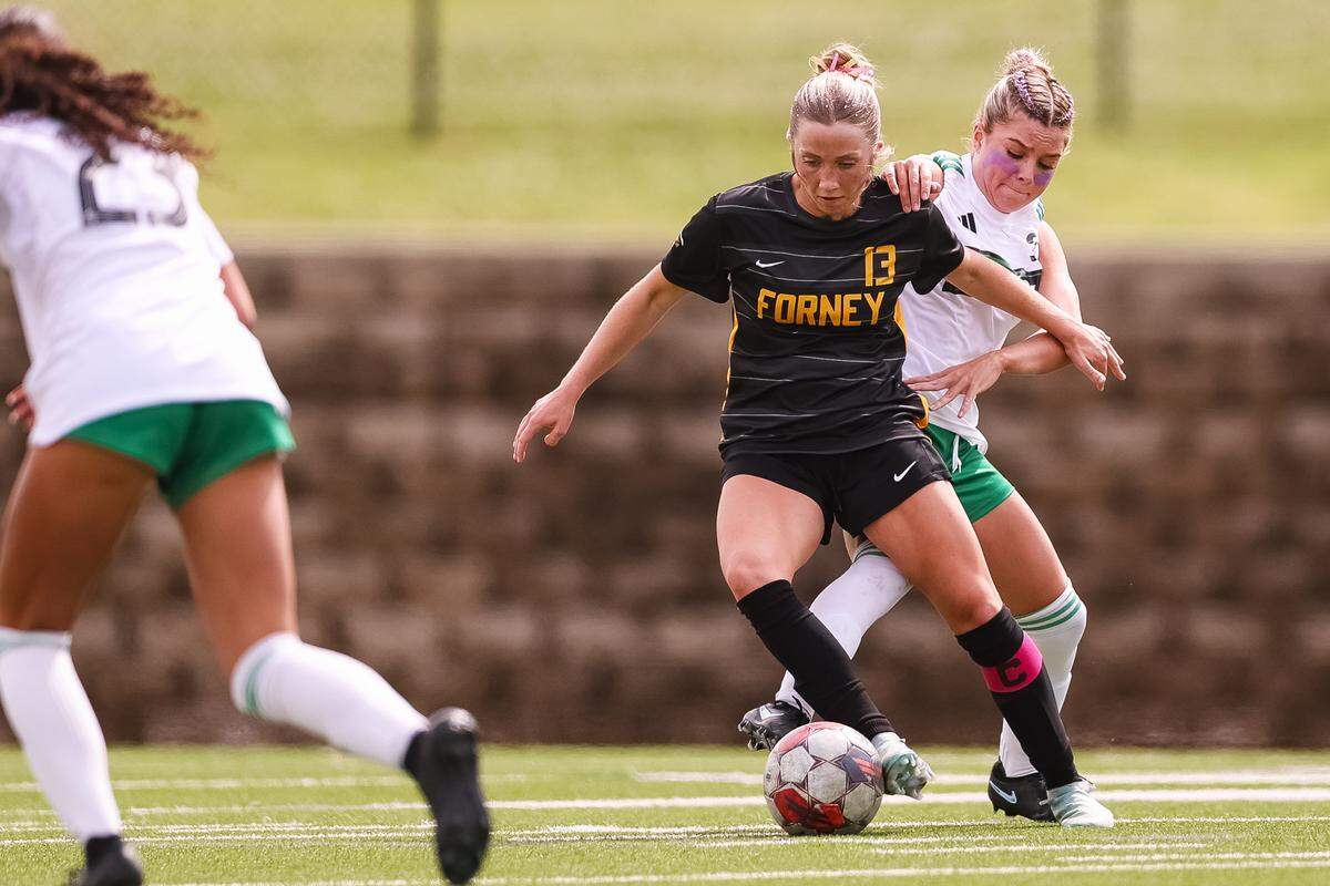 Southlake Carroll midfielder Audrey Anderson (5) battles for the ball with a Forney player in a UIL Class 6A Division 2 girls soccer state semifinal on Saturday, April 4, 2026, at Memorial Stadium in Mesquite, Texas.