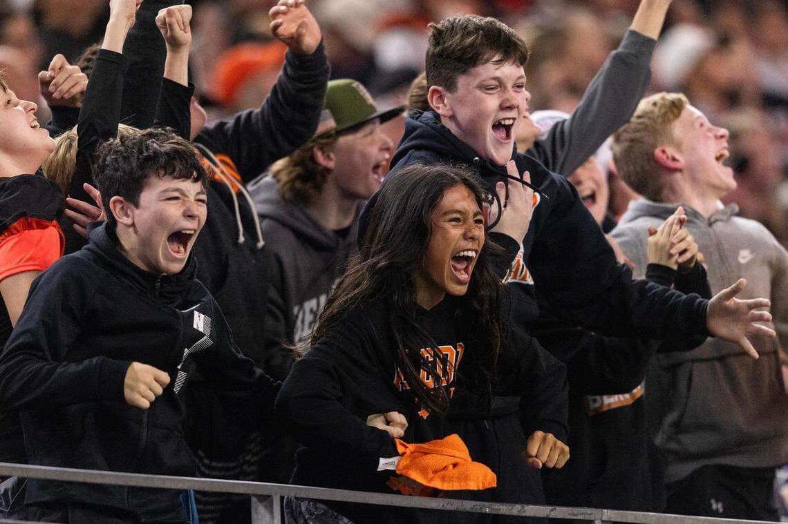 Young Aledo fans celebrate after a touchdown in the third quarter of the 5A Division I football state championship game against the Smithson Valley Rangers at AT&T Stadium in Arlington on Friday, Dec. 15, 2023. Aledo won 51-8 to capture the programs 12th state title.