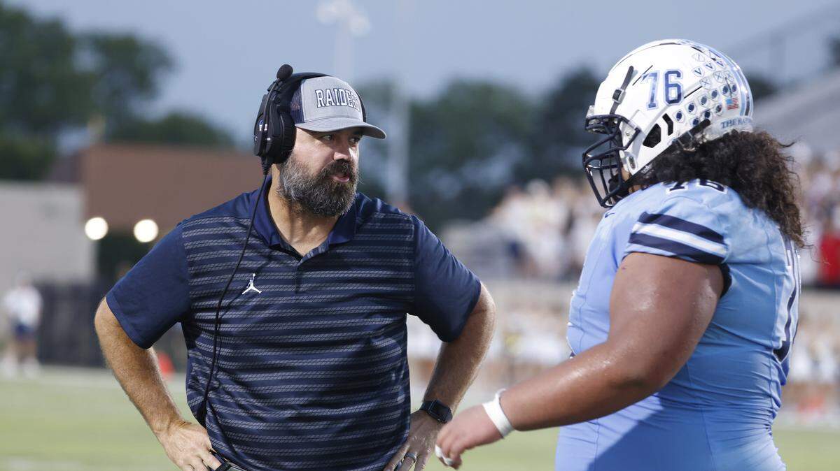 L.D. Bell head coach TJ Dibble talks to offensive lineman Sioeli Tupou (76) after Tupou leaves the field during the first half of a UIL football game between Keller and L.D. Bell at Pennington Field in Bedford, Texas, Friday, Sept. 19, 2025.