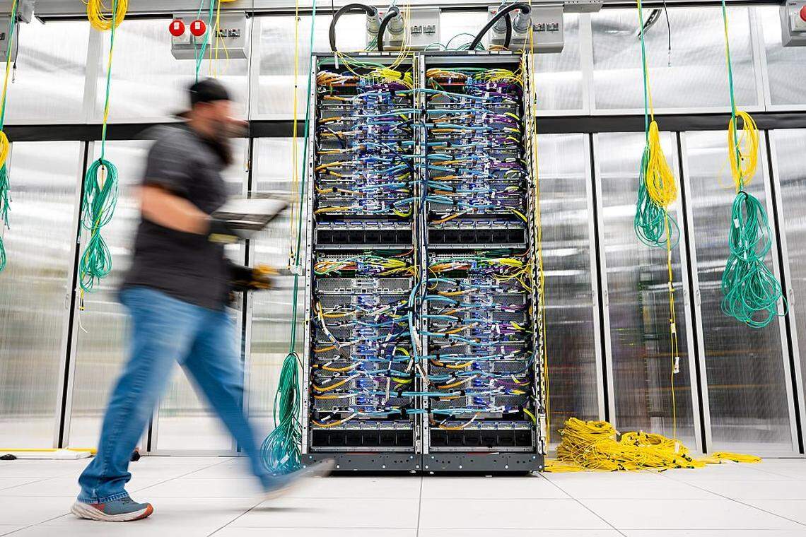 An Amazon Web Services technician passes on a AWS UltraServer in Austin, Texas on October 2, 2025. (Photo by Noah Berger/Getty Images via Amazon Web Services)