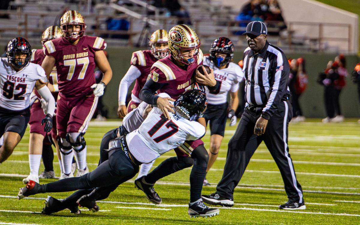 Saginaw quarterback Roman Morales (5) tries to elude Amarillo Tascosa’s Cais Fain (17) during a Class 5A Division 1 area-round game on Friday, Nov. 22, 2024 at Memorial Stadium in Wichita Falls, Texas. Tascosa defeated Saginaw 35-13.