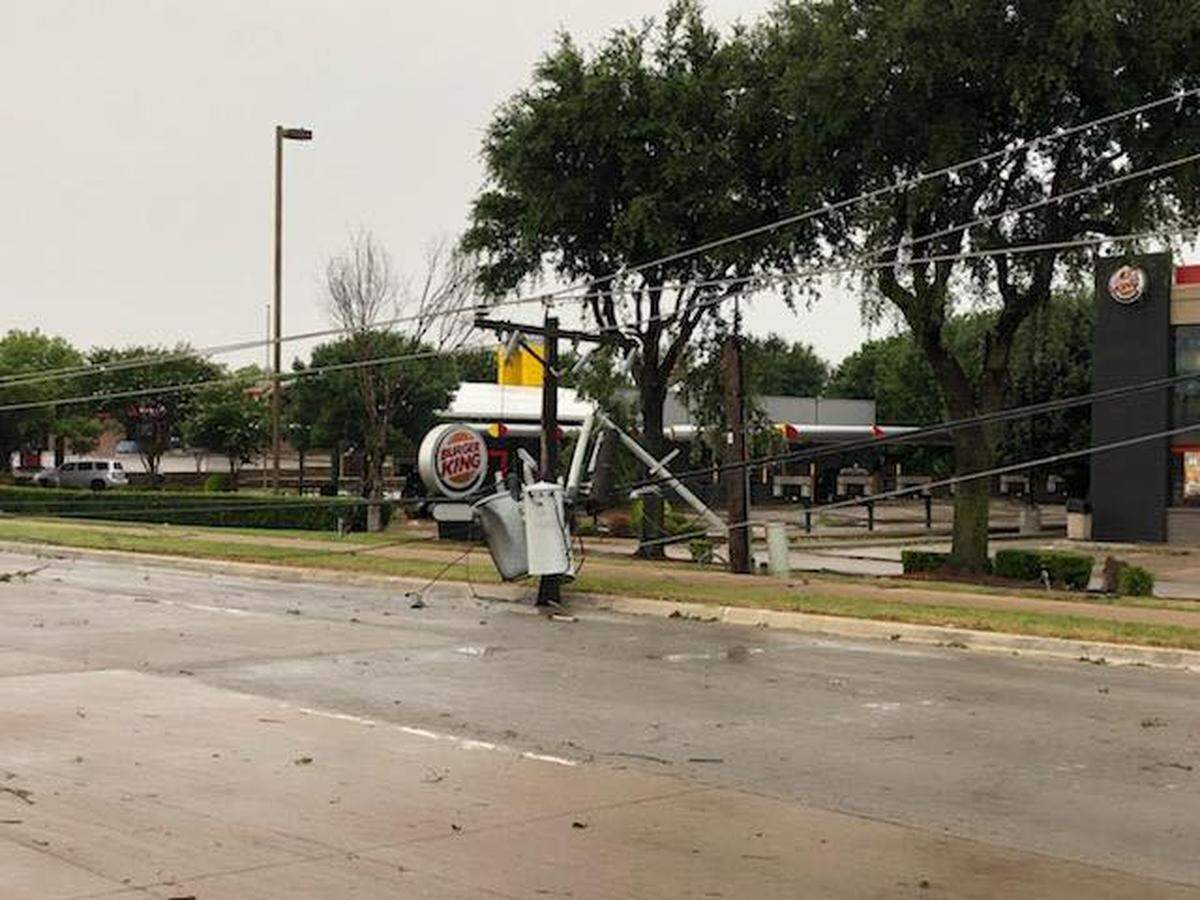 Storms that came through DFW Sunday afternoon left damage in Arlington, such as this sign knocked over on Matlock Road.