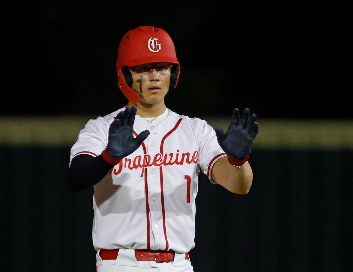 Grapevine pitcher Luke Esquivel (1) asks for a timeout to hand his batting gloves and gear to a coach during a UIL baseball game at Grapevine Mustang Field in Grapevine, Texas, Thursday, Apr. 17, 2025.