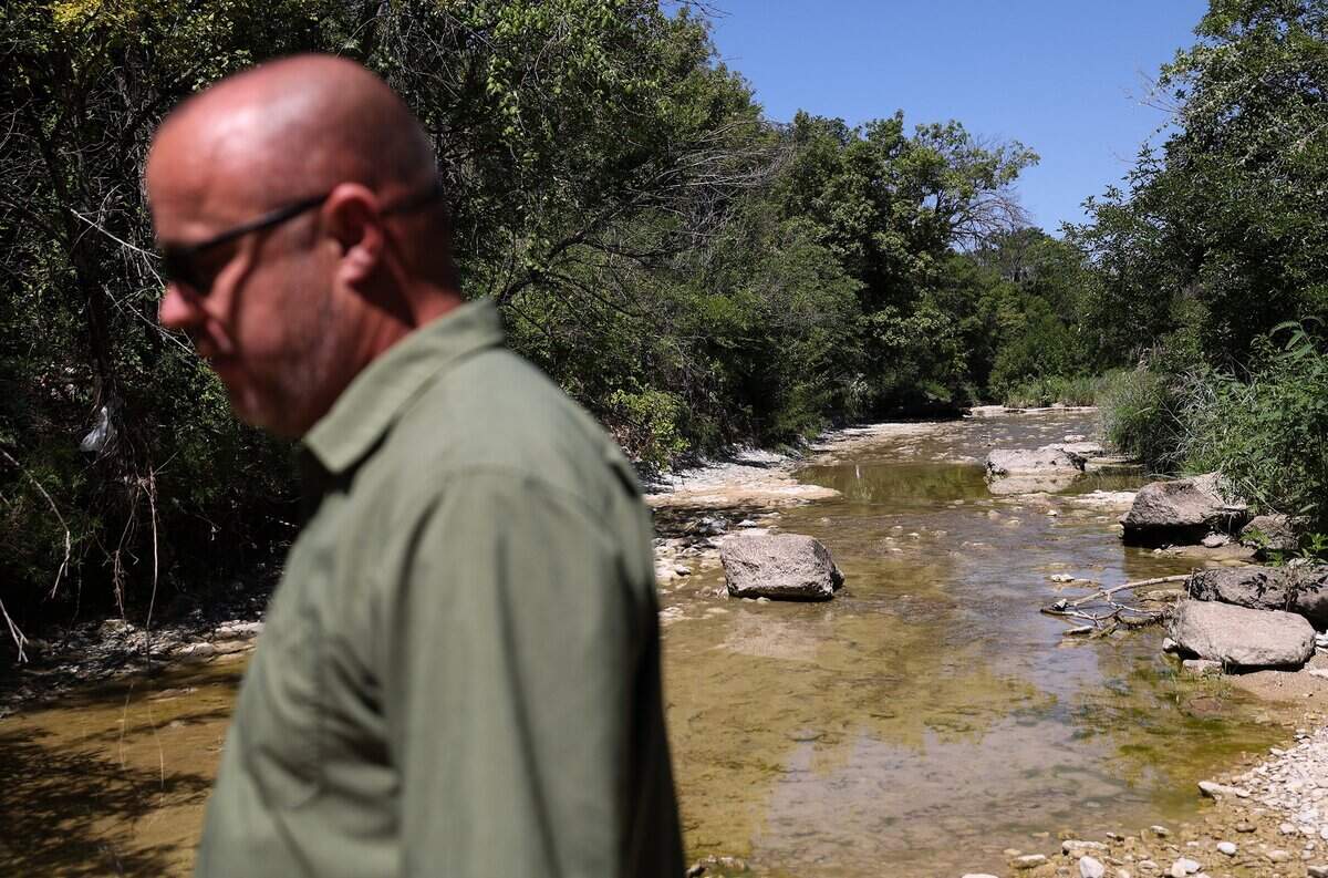 Luke Telford walks along Mary's Creek, a tributary to the Clear Fork of the Trinity River, in Benbrook on Wednesday, July 30, 2025.
