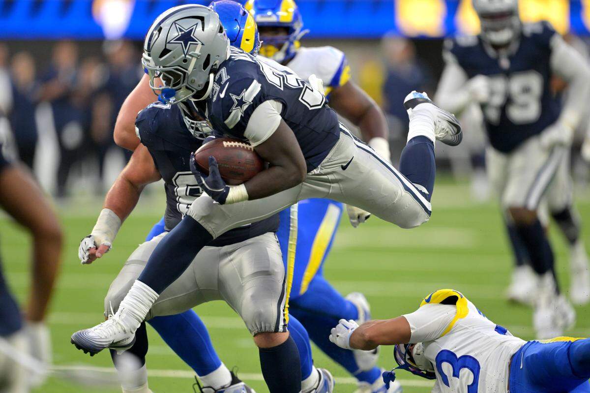 Aug 9, 2025; Inglewood, California, USA; Dallas Cowboys running back Phil Mafah (37) leaps over Los Angeles Rams safety Nate Valcarcel (43) for a first down during the second half at SoFi Stadium. Mandatory Credit: Jayne Kamin-Oncea-Imagn Images