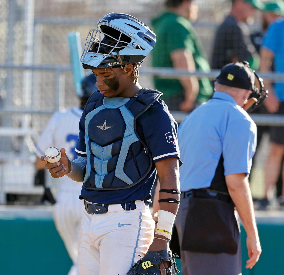Wyatt catcher Jorvorskie Lane (2) checks a ball’s condition after a foul tip during a UIL baseball game at Benbrook High School in Fort Worth, Texas, Thursday, Feb. 22, 2024.