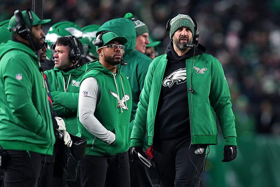 Eagles defensive passing game coordinator Christian Parker (center), standing next to head coach Nick Sirianni (right), has been hired as the Cowboys’ new defensive coordinator.