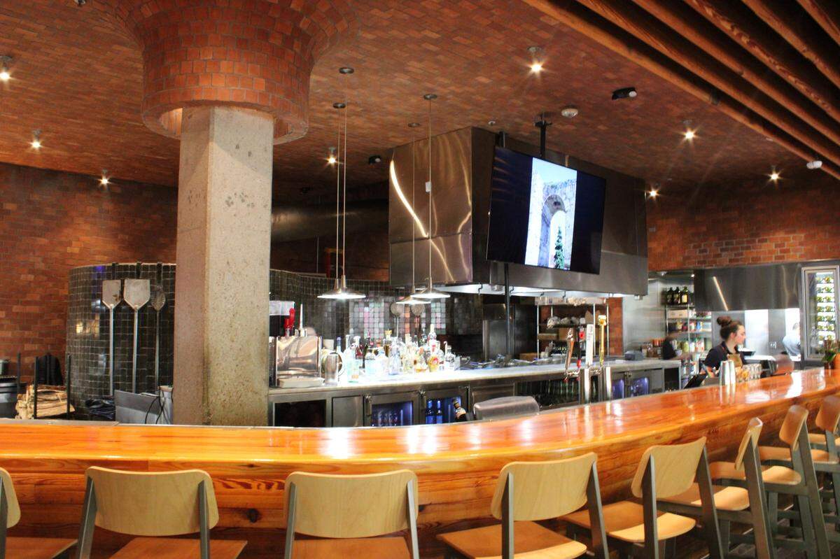 Guest have an unobstructed view of the Si Tapas kitchen and the ovens in the back wall that once baked the bread for a Firehouse Subs. Now, it roasts suckling pigs, a restaurant specialty.