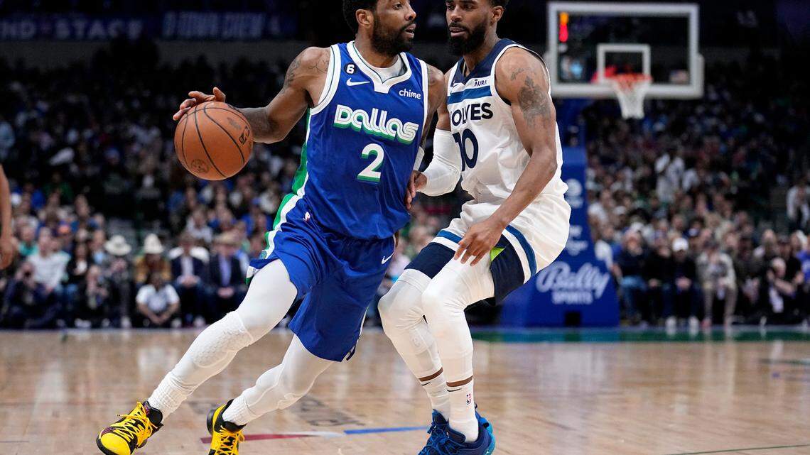 Dallas Mavericks guard Kyrie Irving (2) works against Minnesota Timberwolves’ Mike Conley, right, on Monday at American Airlines Center. 