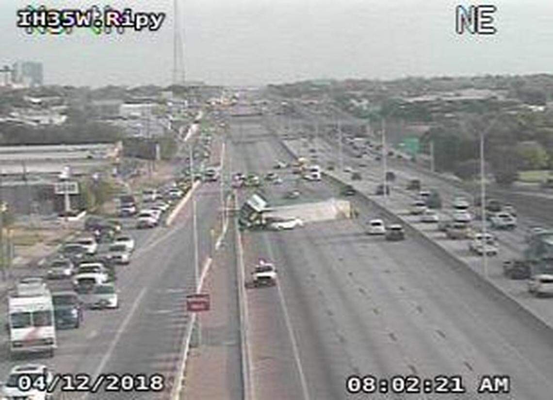 The overturned trailer still took up most of the freeway shortly after 8 a.m. Thursday.