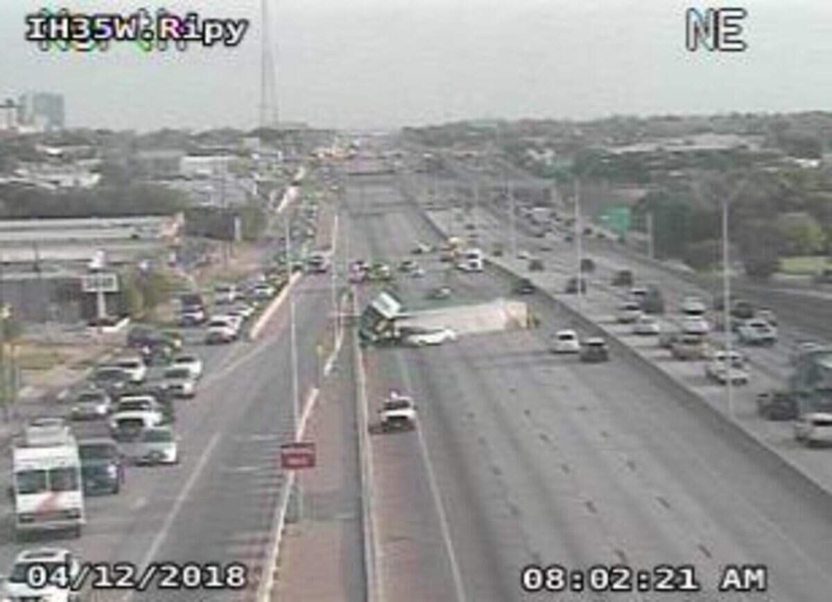 The overturned trailer still took up most of the freeway shortly after 8 a.m. Thursday.