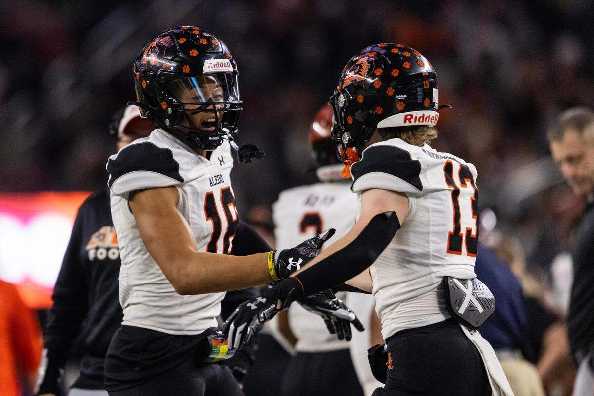 Aledo wide receiver Kaydon Finley (18) celebrates with his teammate Colton McCoy (13) after scoring a touchdown in the second quarter of the 5A Division I Football State Championship game against the Comal Smithson Valley Rangers at AT&T Stadium in Arlington on Friday, Dec. 15, 2023.