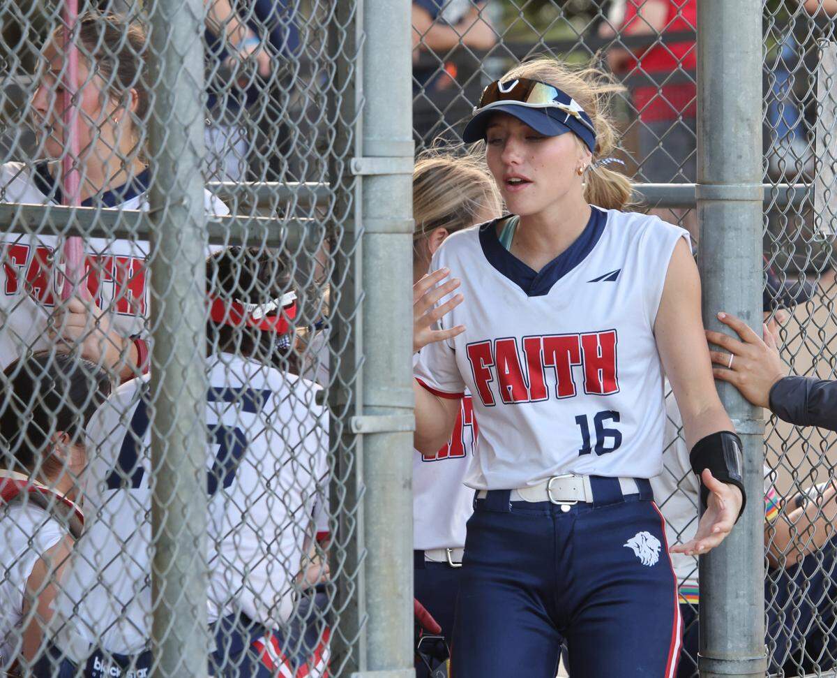 Grapevine Faith center fielder Michaela Hamilton jokes around with team mates in the dugout during a softball game at Oak Grove Park in Grapevine, Tx. Tuesday, March 31, 2026