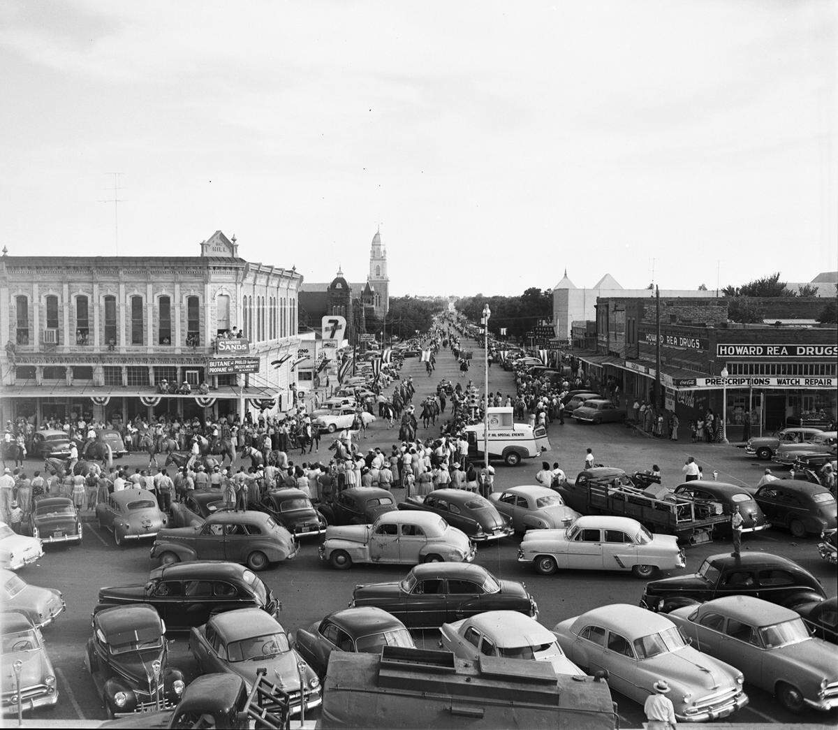 July 29, 1953: A parade in Weatherford, Texas, for the opening of Rodeo and Frontier Day celebrations sponsored by the Parker County Sheriff’s Posse; looking south on Main Street from the Courthouse