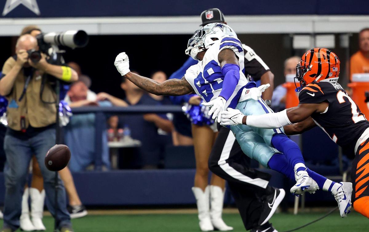Dallas Cowboys wide receiver CeeDee Lamb reaches for a long pass while Cincinnati Bengals cornerback Chidobe Awuzie defends on Sunday, September 18, 2022.