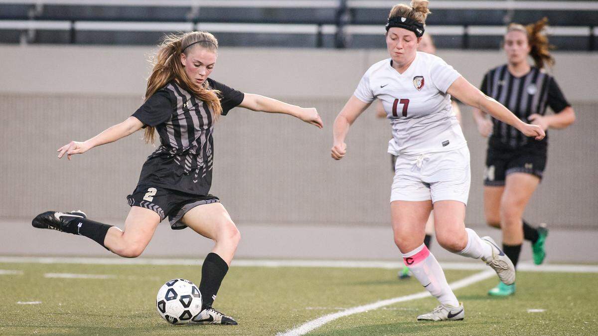 From area round playoffs, Mansfield’s Berkeley Koch (2) lines up a shot as Keller Central’s Maddie McElwee converges.