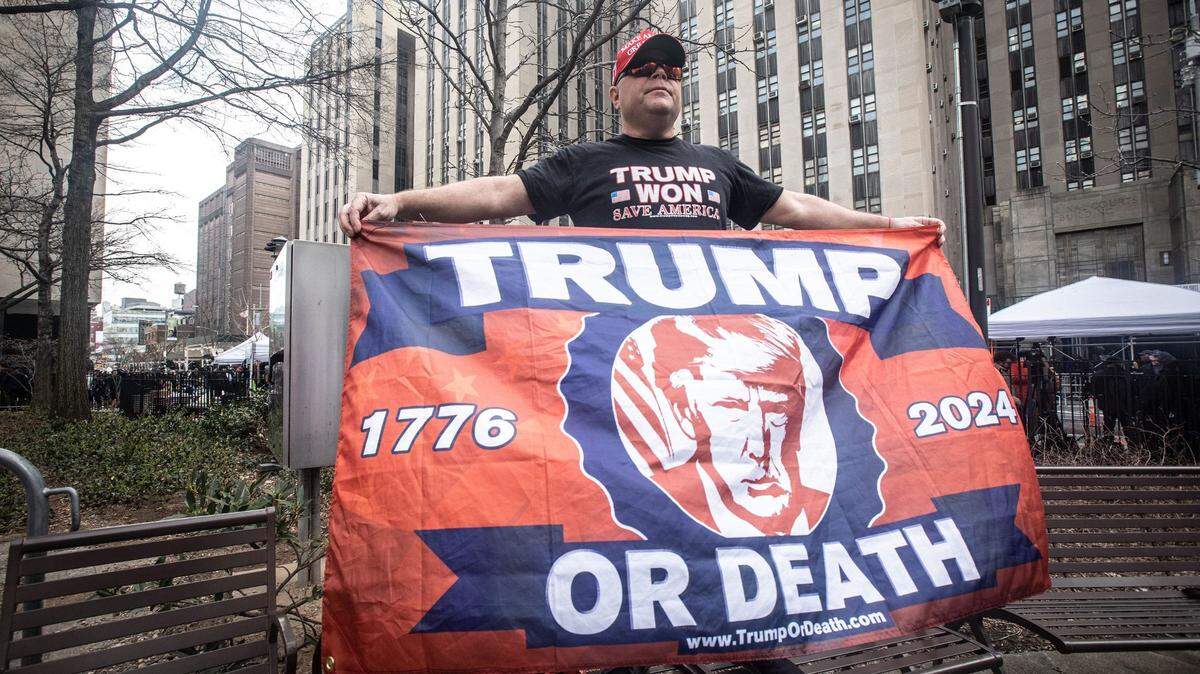No indictment or accusation is likely to shake the loyalty of Donald Trump supporter’s such as Dion Cini of Brooklyn, shown holding a sign across the street from a New York courthouse where Trump was arraigned in April.