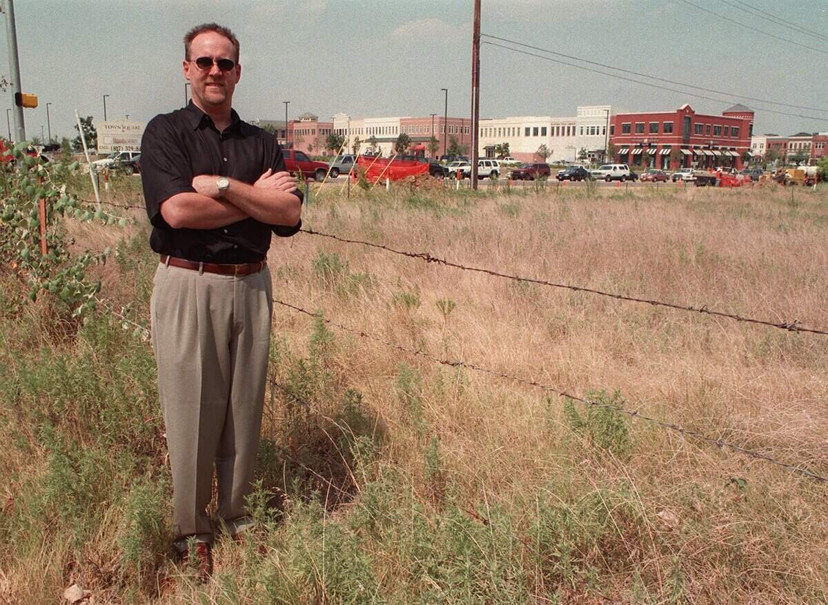 Aug. 4, 1999: Jerry Gibson, a board member of the Southlake Oak Tree Estates Homeowner's Association, stands in front of property that will be the site of a proposed shopping center across Southlake Boulevard from Town Square. Gibson's association opposes the proposed shopping center.