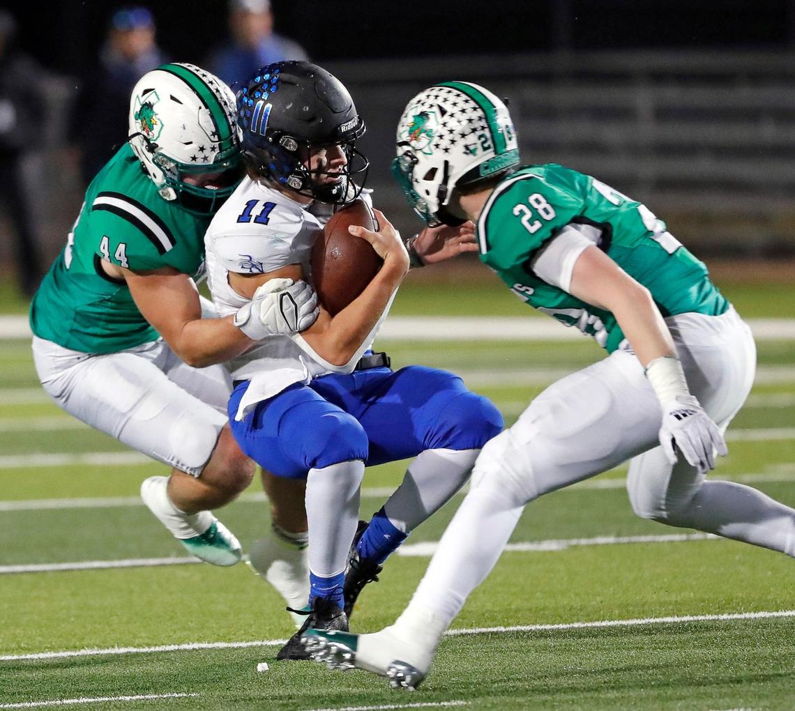 Southlake Carroll defensive lineman Dustan Mark (44) sacks Byron Nelson quarterback Jake Wilson (11) as linebacker Aaron Scherp (28) moves in to help in the first half of a District 4-6A football game at Dragon Stadium in Southlake, Texas, Friday, Oct. 28, 2022. Carroll led Byron Nelson 21-13 at the half. (Special to the Star-Telegram Bob Booth)