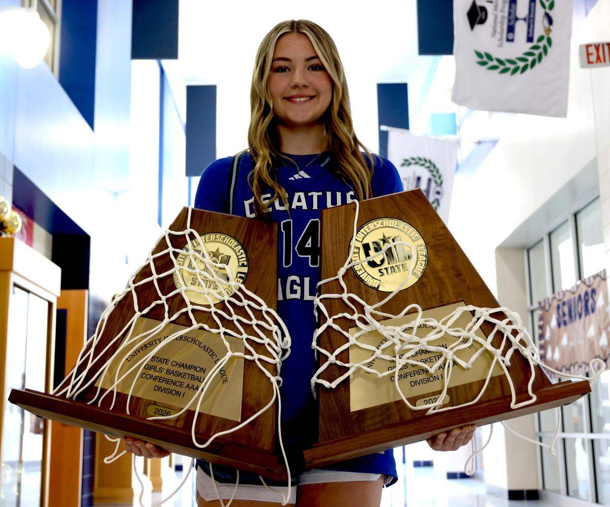 Decatur High School point guard Style Brazile holds the two Class 4A Division I State Championship trophies from 2025 and 2026 at Decatur High School in Decatur, Tx. Tuesday, March 31, 2026