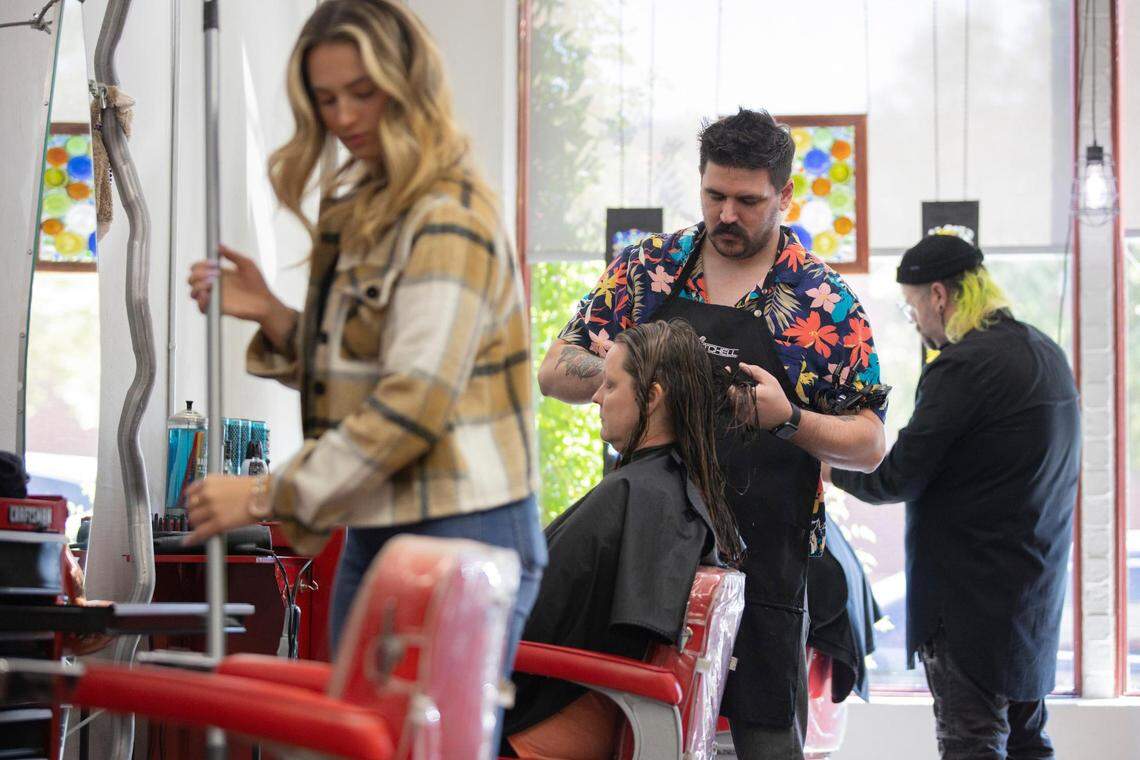Alex Frazier cuts the hair of his client at Magnolia Ave. Salon in Fort Worth, Texas, on Saturday, Sept. 10, 2022.