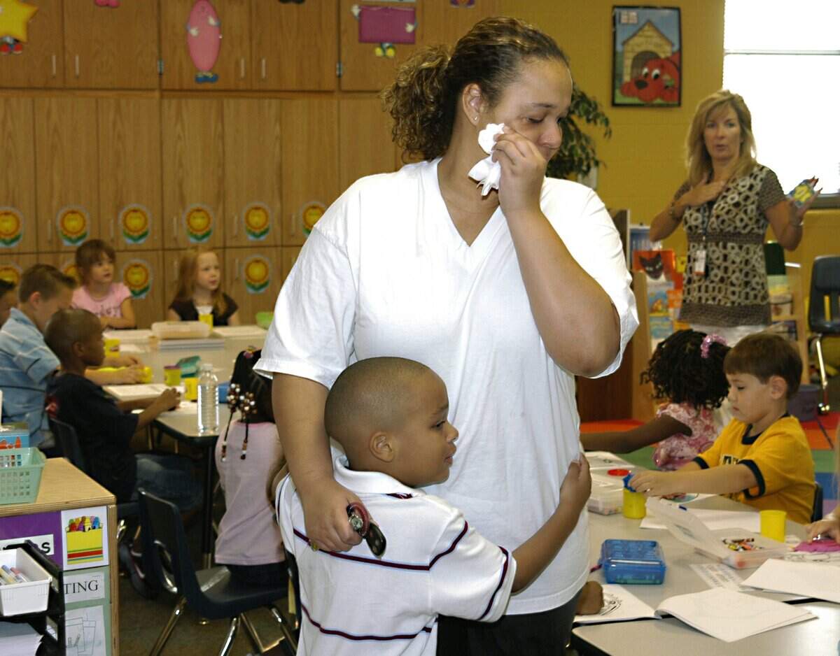 Aug. 27, 2007: Natasha Lane wipes away tears while hugging her son, Jailynn Lane 5, as he attends kindergarten on the first day of school at Reid Elementary in Mansfield.