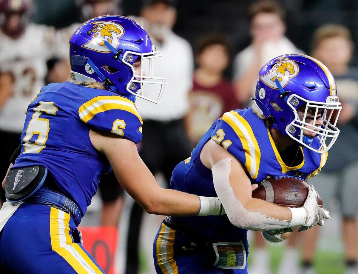 Brock quarterback Tyler Moody (6) hands the ball to running back Kutter Wilson (21) during a high school Class 3A Division 1 Quarterfinals playoff game at Globe Life Field in Arlington, Texas, Thursday, Dec. 02, 2021. Brock led 28-0 at the half. (Special to the Star-Telegram Bob Booth)