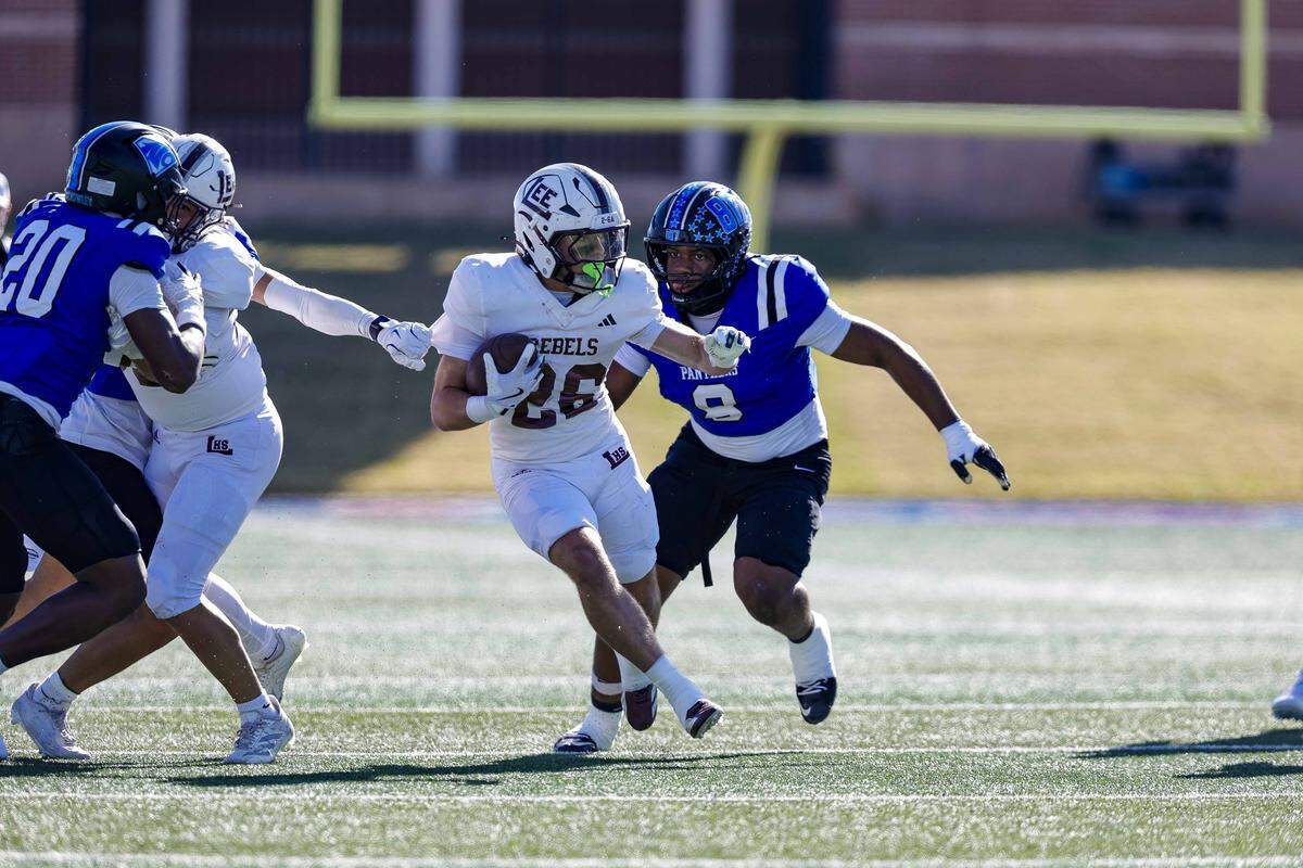 North Crowley defensive tackle DeMorey Beasley (8) and linebacker Brock Lacy (20) close in on Midland Legacy running back Hayes Hamm (26) in a Class 6A Division I area-round playoff Saturday.