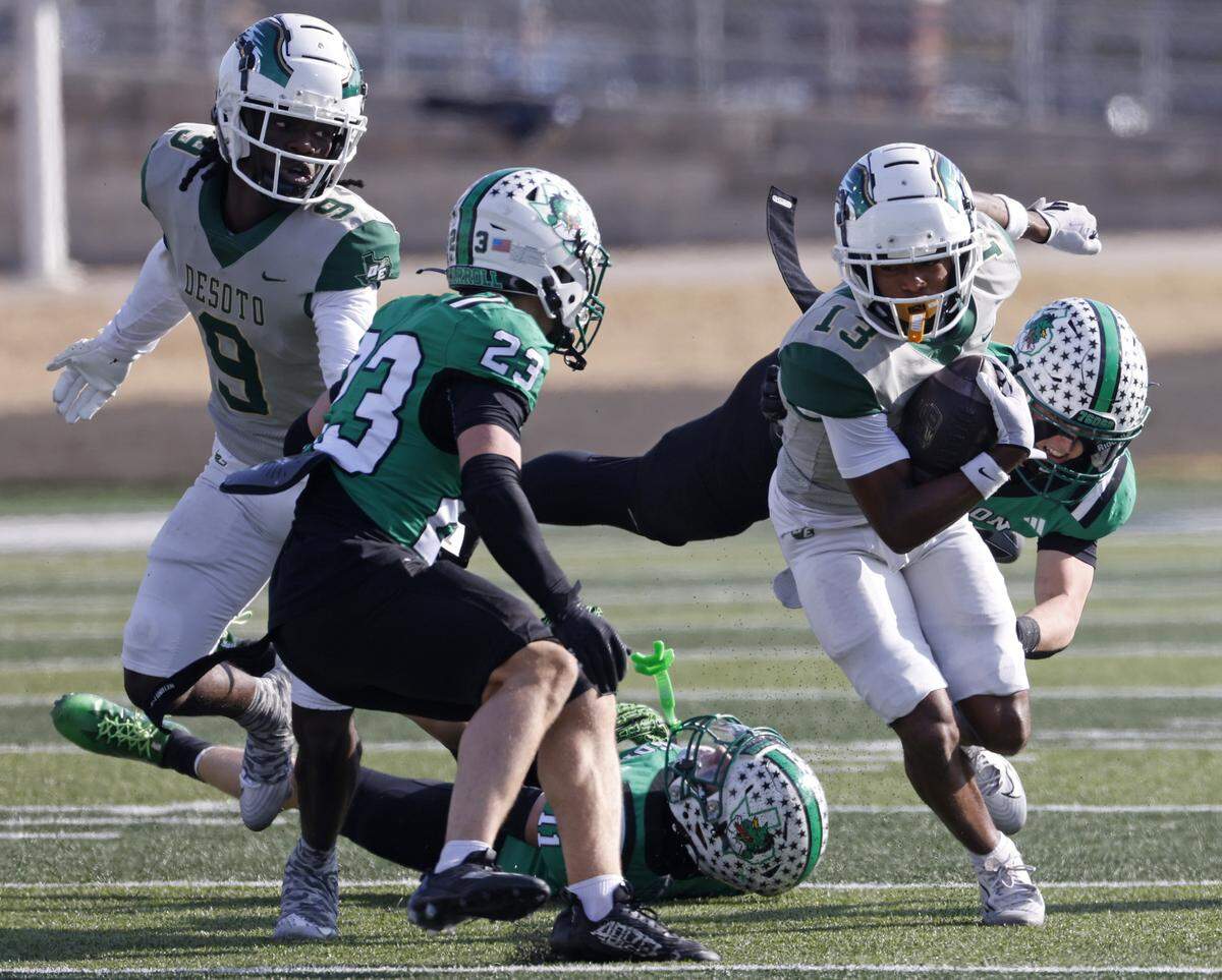 DeSoto wide receiver Courtly'on Jackson (13) works up the middle against Southlake Carroll defensive back Austin Bussmann (23) during the first half of a UIL Class 6A Division II semifinal on Saturday Dec. 13, 2025 at Vernon Newsom Stadium in Mansfield, Texas.