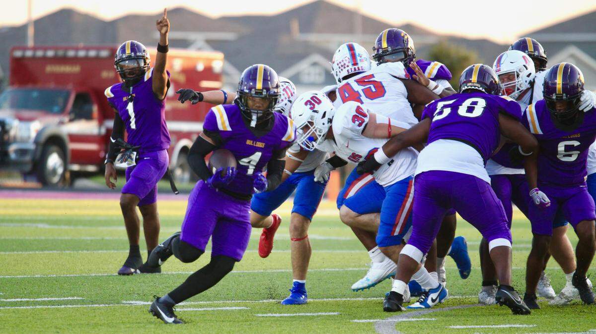 Everman running back Lebron Bowdy runs through a hole against Grapevine in a District 3-5A D2 game on Friday, September 12, 2025 at Marr Stadium in Everman, Texas.