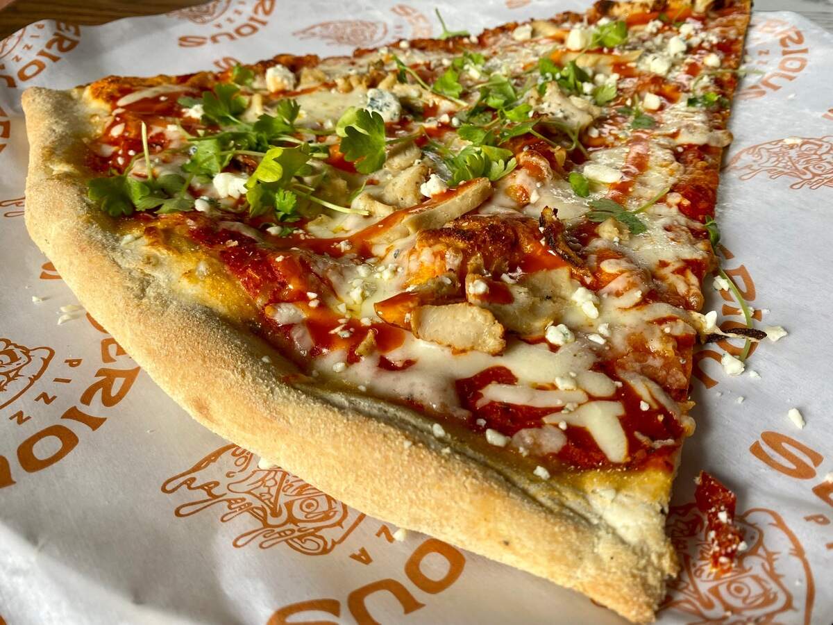 A Buffalo chicken pizza slice at Serious Pizza in Fort Worth.