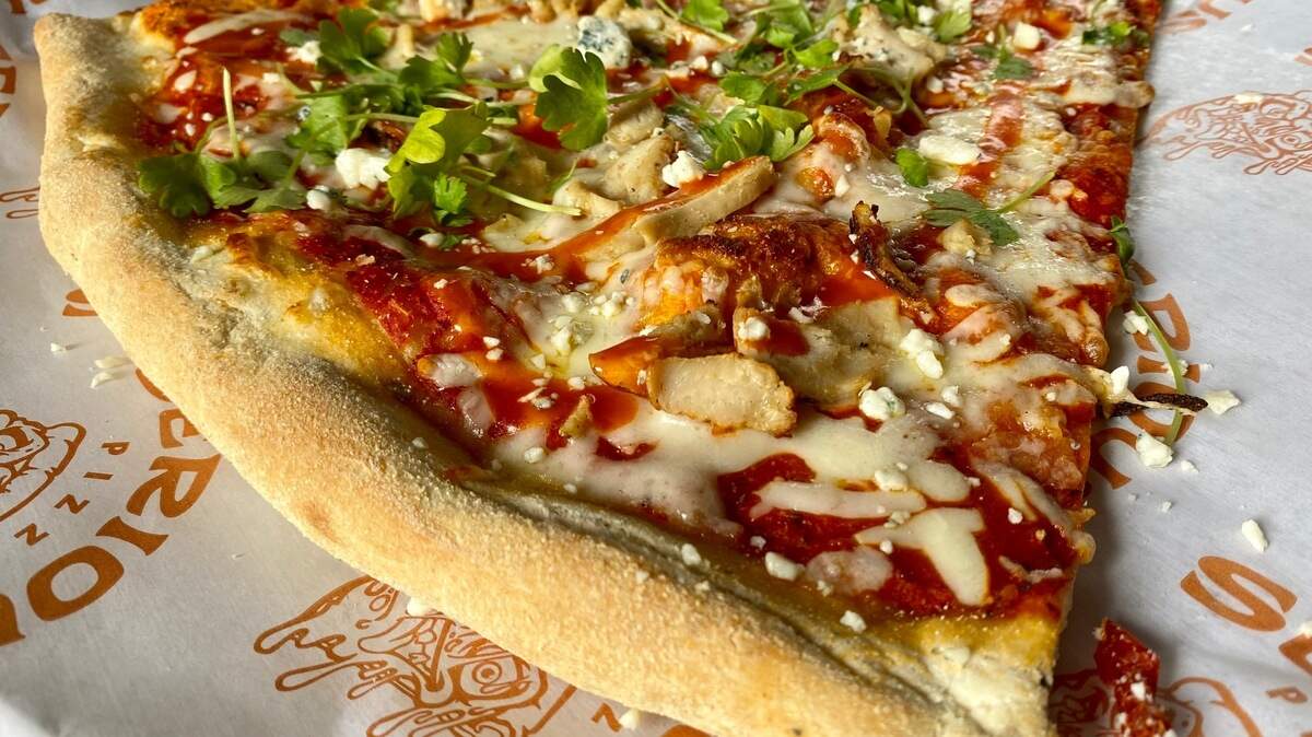 A Buffalo chicken pizza slice at Serious Pizza in Fort Worth.