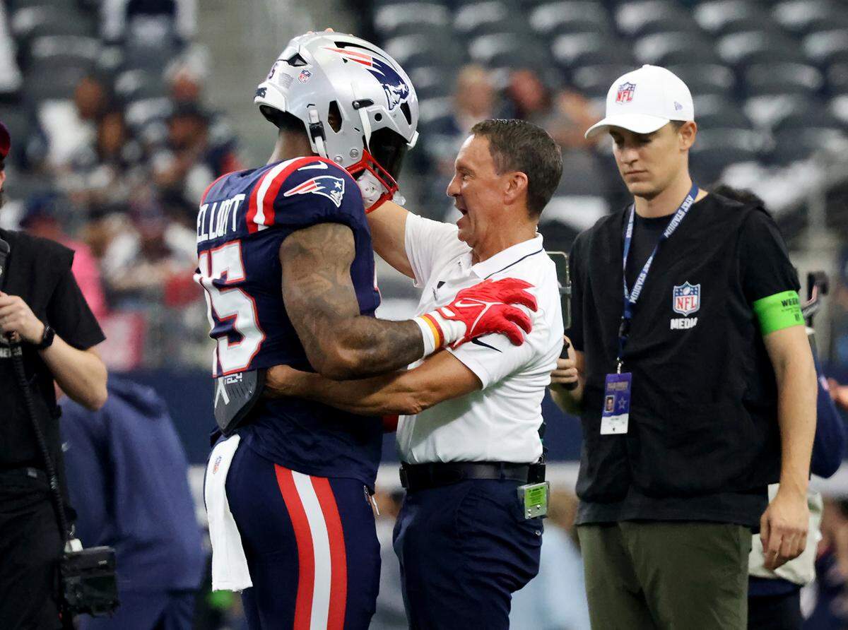 New England Patriots running back Ezekiel Elliott hugs Cowboy’s long-time trainer Britt Brown while warming up at AT&T Stadium on Sunday, October 1, 2023, in Arlington.
