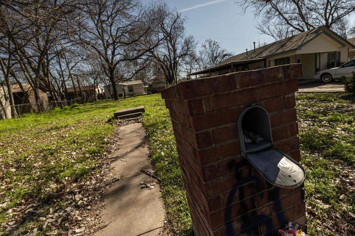 An empty lot is located between two residential houses in the Greenway neighborhood of Fort Worth on Wednesday, Feb. 21, 2024. Greenway is getting increased attention from home builders looking to purchase land close to downtown which increases property taxes for residents who might not be able to afford the hefty prices.