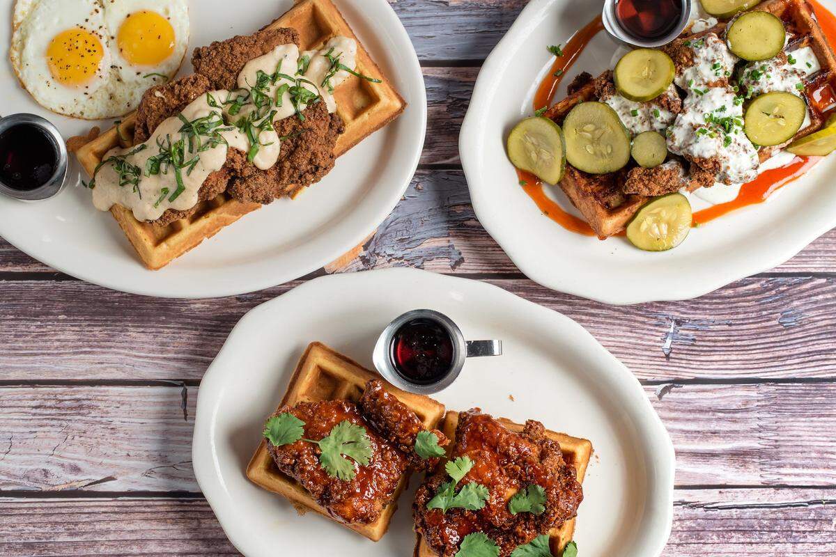 Tupelo Honey Southern Kitchen has three versions of chicken and waffles, from left: country-style, Sriracha-honey, and mac-and-cheese on Asheville hot chicken.