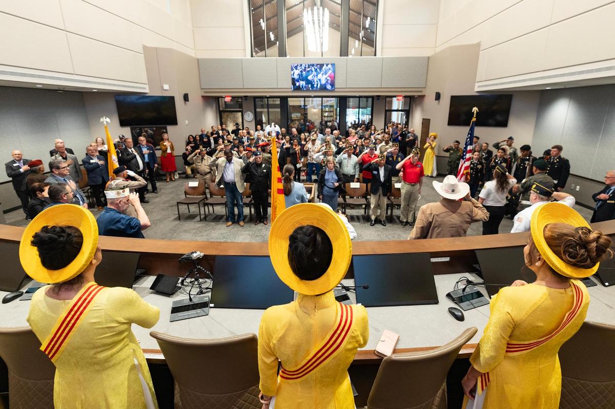 Vietnam war veterans, politicians and dignitaries stand up for the national anthem to begin the 50th Anniversary of the Vietnam War event at Haltom City City Hall in Fort Worth on Wednesday, April 30, 2025.