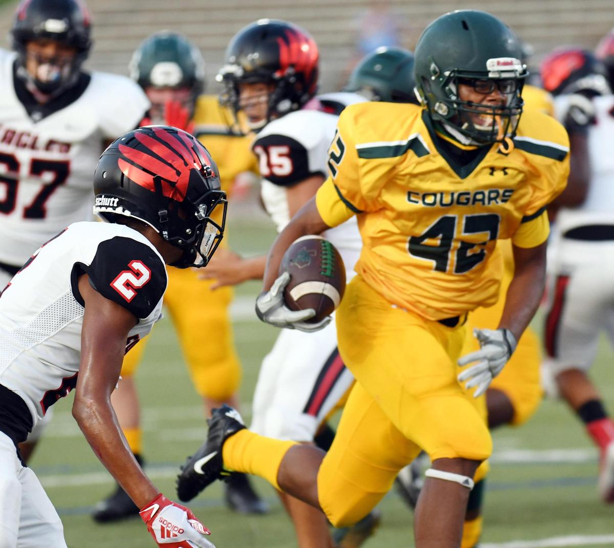Western Hills’s Jason Green right runs past Diamond Hill Jarvis’s Jose Chavas Rincon for a touchdown to take a 7-0 lead in the first quarterof their football game at Clark Stadium Thursday, September 17, 2020 in Fort Worth, Texas. Special/Bob Haynes