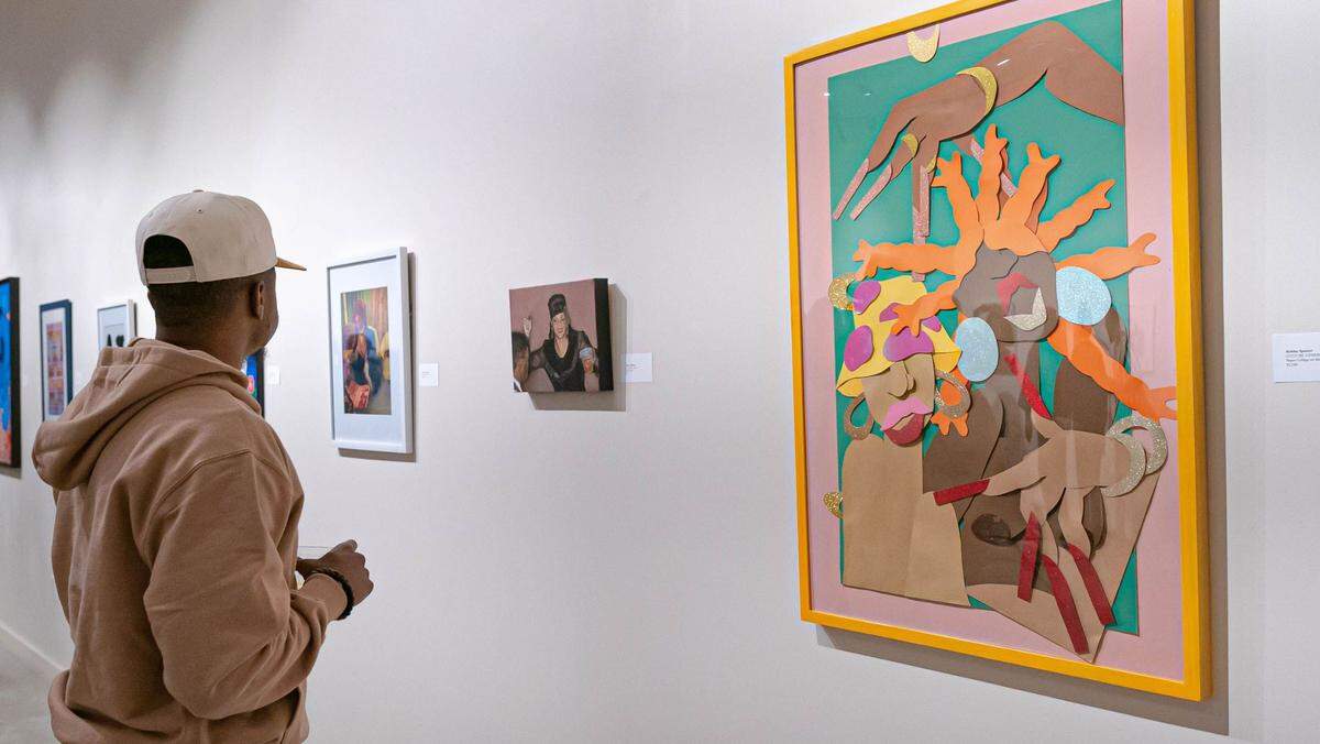 A viewer at the opening reception of the Sunday’s Best exhibit at Zona 7 art gallery at 404 Houston St. The exhibit runs through March 16.