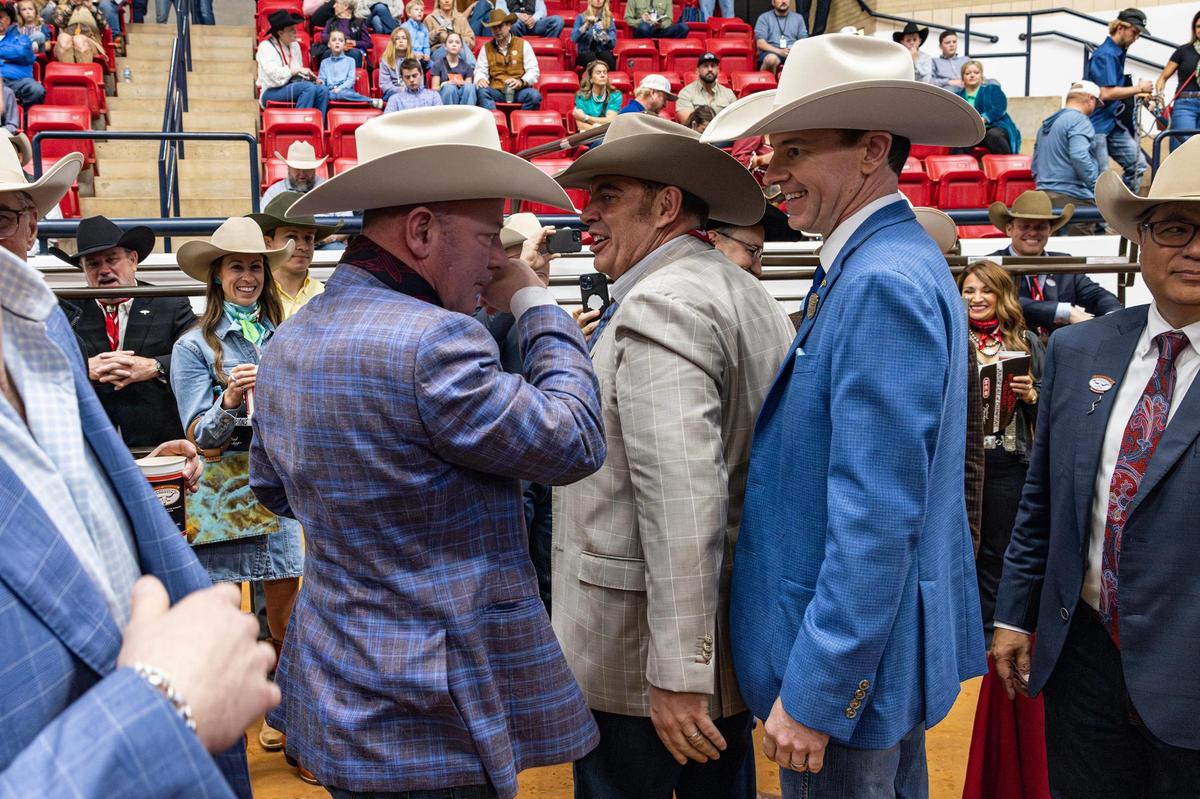 Members of Vaden’s Drywall, Plaster and Masonry celebrate after winning the auction for the grand champion steer, Alley Cat, for $375,000 at the Auction of Champions for the Fort Worth Stock Show & Rodeo in the Wyatt Arena on Saturday, Feb. 8. 2025.