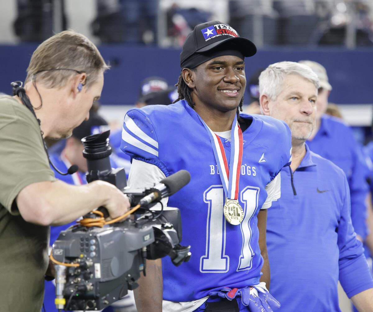Yoakum wide receiver X'Zavier Barnett (11) is escorted to the podium to receive offensive MVP after defeating Grandview in the UIL Class 3A Division I championship game on Thursday Dec. 18, 2025 at AT&T Stadium in Arlington, Texas.
