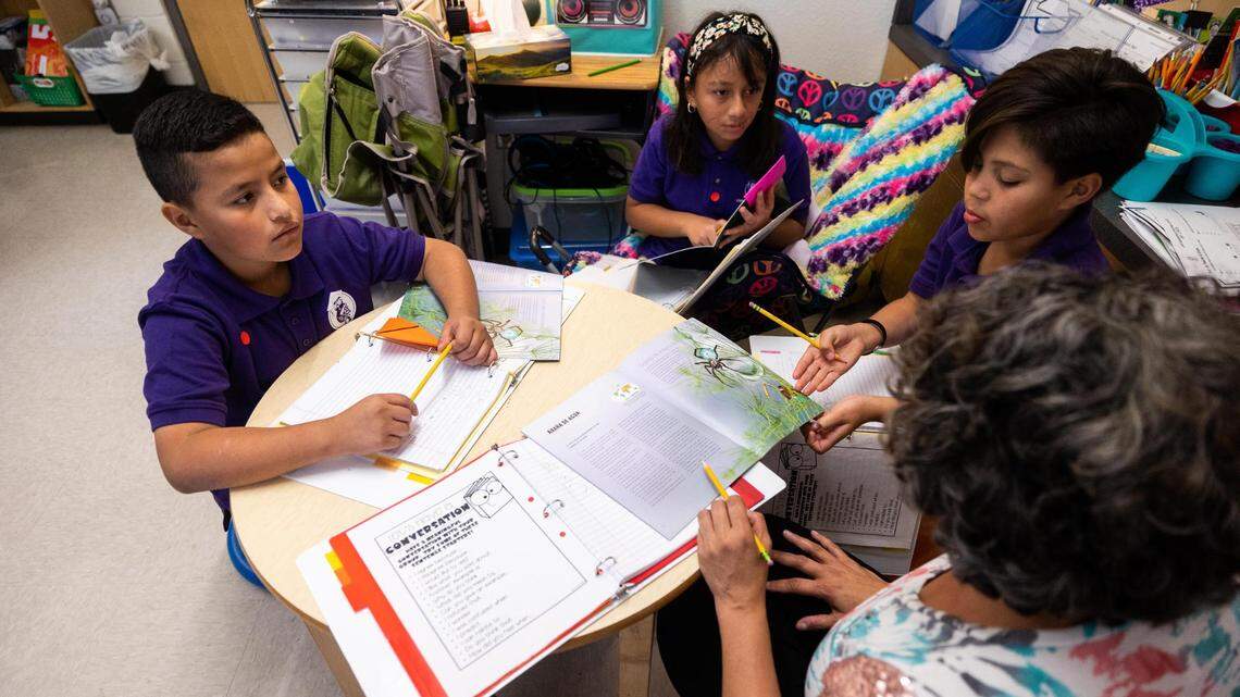 Students chat during book club at Zaida Johnson’s fourth-grade class on Thursday, Oct. 6, 2022, at Leadership Academy at John T. White Elementary School in Fort Worth.