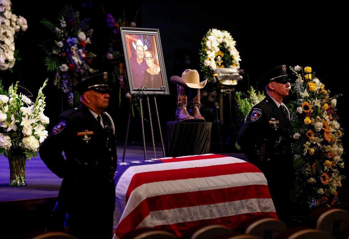 Members of the Arlington Police Department stand beside the coffin of Officer Darrin McMichael during his funeral on Wednesday, September 27, 2023, at Crossroads Christian Church in Grand Prairie. McMichael, a member of Arlington’s Motorcycle Unit, was killed on Sept. 21 while on his way to work.