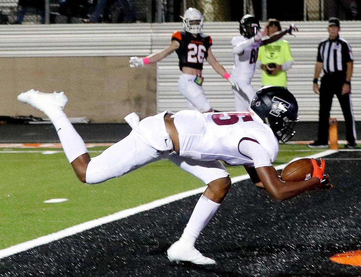 Timberview wide receiver Titus Evans (15) grabs a touchdown throw off the carpet in a high school district 5-5A division 2 football game at Bearcat Stadium in Aledo, Texas, Friday Oct. 15, 2021. After a late second quarter Timberview touchdown the score was knotted at 14 at the half. (Special to the Star-Telegram Bob Booth)