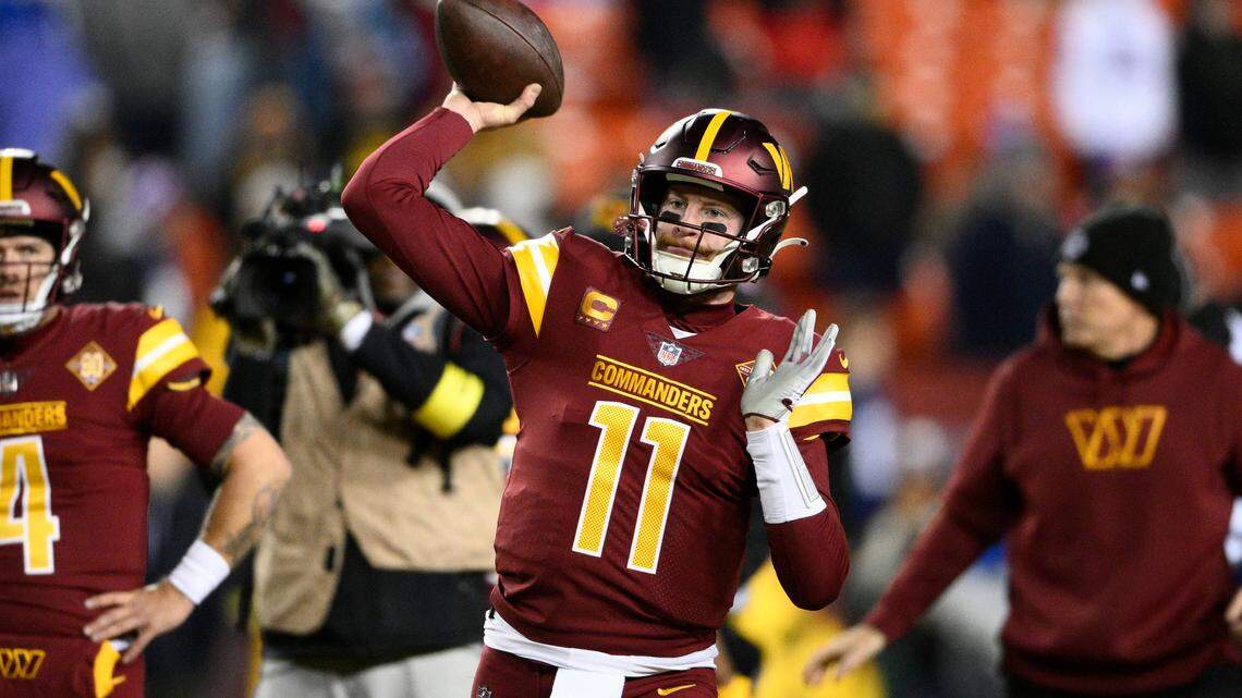 Washington Commanders quarterback Carson Wentz (11) warms up before an NFL football game this season.
