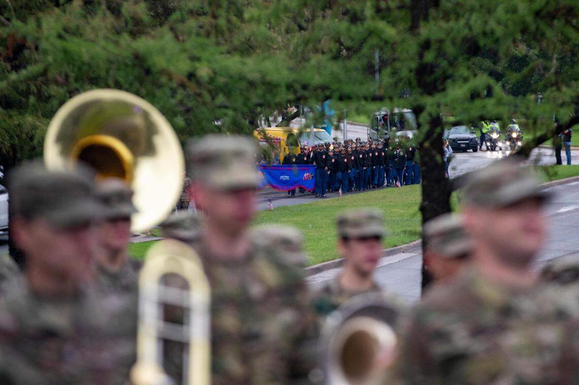 A military band leads the Veterans Day Parade as ROTC cadets follow behind in Fort Worth on Friday, Nov. 11, 2022. Despite rain, hundreds of participants marched down North Forest Park Boulevard, waving American flags and signing a medley of military songs.